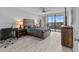 Cozy bedroom with wood bed frame, gray bedding, and ample natural light at 220 Belleview Blvd # 607, Belleair, FL 33756