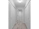 Hallway with built-in storage and light wood-look flooring at 220 Belleview Blvd # 607, Belleair, FL 33756