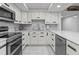 Modern white kitchen with stainless steel appliances at 220 Belleview Blvd # 607, Belleair, FL 33756