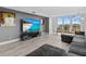 Modern living room with large TV and gray couch at 220 Belleview Blvd # 607, Belleair, FL 33756