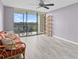Living room with hardwood floors, balcony view, and comfy couch at 220 Belleview Blvd # 607, Belleair, FL 33756