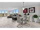 Spacious living room with gray sectional sofa and glass dining table at 220 Belleview Blvd # 607, Belleair, FL 33756