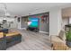 Spacious living room with hardwood floors, large TV, and open floor plan at 220 Belleview Blvd # 607, Belleair, FL 33756