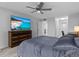 Main bedroom with a large TV and ceiling fan at 220 Belleview Blvd # 607, Belleair, FL 33756