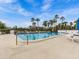 Inviting community pool with palm trees and lounge chairs at 220 Belleview Blvd # 607, Belleair, FL 33756