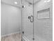 Shower with marble-like wall tiles and glass enclosure at 220 Belleview Blvd # 607, Belleair, FL 33756