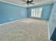 Spacious bedroom with blue walls and window at 24932 Ravello St, Land O Lakes, FL 34639