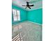 Bright bedroom with teal walls and ceiling fan at 24932 Ravello St, Land O Lakes, FL 34639