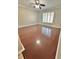 Spacious living room featuring hardwood floors and a window with shutters at 24932 Ravello St, Land O Lakes, FL 34639