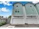 Modern teal three-unit building with attached garages at 2819 1St S Ave, St Petersburg, FL 33712