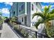 Private paved patio with pergola, landscaping, and black metal fence at 2819 1St S Ave, St Petersburg, FL 33712