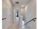 Upstairs hallway with carpet, doors to bedrooms, and stairs at 2819 1St S Ave, St Petersburg, FL 33712