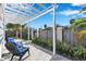 White pergola with blue chairs and landscaping at 2819 1St S Ave, St Petersburg, FL 33712