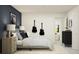 Modern bedroom with a bed, nightstands, and guitars at 32208 Jamaica Caper Way, San Antonio, FL 33576