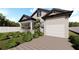 Home with a large garage and a walkway at 3305 W Oak Ave, Plant City, FL 33563