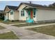 Tan bungalow with orange door and teal steps at 331 25Th S St, St Petersburg, FL 33712