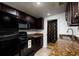 Galley kitchen with dark wood cabinets and granite counters at 331 25Th S St, St Petersburg, FL 33712