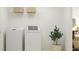 Bright laundry room with washer, dryer, and shelving at 3634 Forest Path Dr, Plant City, FL 33565