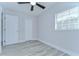 Bright bedroom with ceiling fan, wood-look floors, and ample closet space at 4113 Leonard St, Valrico, FL 33594