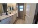 Modern bathroom with double vanity and walk-in shower at 4410 Summer Savory St, Tampa, FL 33619