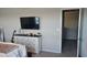 Bedroom with a dresser, mounted TV and access to loft area at 4410 Summer Savory St, Tampa, FL 33619