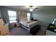 Spacious bedroom with a queen bed and ample natural light at 4410 Summer Savory St, Tampa, FL 33619