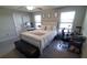 Bright bedroom with a queen bed, workspace, and ample natural light at 4410 Summer Savory St, Tampa, FL 33619
