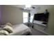Bedroom with a queen bed, TV, and large mirror at 4410 Summer Savory St, Tampa, FL 33619