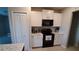 Modern kitchen with white cabinets, granite countertops, and stainless steel appliances at 4410 Summer Savory St, Tampa, FL 33619