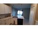 Modern kitchen with white cabinets, granite countertops, and stainless steel appliances at 4410 Summer Savory St, Tampa, FL 33619