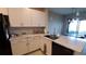 Modern kitchen with white cabinets, granite countertops, and stainless steel appliances at 4410 Summer Savory St, Tampa, FL 33619