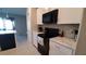 Modern kitchen with white cabinets, granite countertops, and stainless steel appliances at 4410 Summer Savory St, Tampa, FL 33619