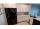 Modern kitchen with white cabinets, granite countertops, and stainless steel appliances at 4410 Summer Savory St, Tampa, FL 33619
