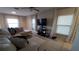 Living room with sectional sofa and two windows at 4410 Summer Savory St, Tampa, FL 33619