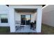 Covered patio with table, chairs, and grill; perfect for outdoor dining at 4410 Summer Savory St, Tampa, FL 33619
