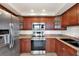 Modern kitchen with stainless steel appliances and wood cabinets at 6365 Bahia Del Mar Blvd # 604, St Petersburg, FL 33715