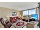 Living room with leather furniture and a large window with city view at 6365 Bahia Del Mar Blvd # 604, St Petersburg, FL 33715