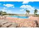 Relaxing pool area, multiple lounge chairs, and water view at 6365 Bahia Del Mar Blvd # 604, St Petersburg, FL 33715