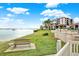 Peaceful waterfront view with a park bench and grassy area at 6365 Bahia Del Mar Blvd # 604, St Petersburg, FL 33715