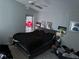 Bedroom with a king-size bed, ceiling fan, and multiple wall art pieces at 6905 Sotra St, Wesley Chapel, FL 33545