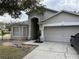 Two-story house with attached garage and landscaping at 6905 Sotra St, Wesley Chapel, FL 33545