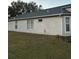 Side view of house showing windows and yard at 6905 Sotra St, Wesley Chapel, FL 33545