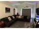 Spacious living room with sectional sofa and large TV at 6905 Sotra St, Wesley Chapel, FL 33545