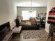 Small office or den with black couch and desk at 6905 Sotra St, Wesley Chapel, FL 33545