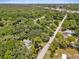 Aerial view of residential neighborhood with tree-lined streets at 7803 Cadillac Ave, Hudson, FL 34667