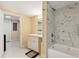 Updated bathroom with marble shower and white vanity at 7803 Cadillac Ave, Hudson, FL 34667