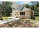 Tan two-story house with white trim, balcony, and a walkway at 7803 Cadillac Ave, Hudson, FL 34667