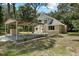 Two-story house with carport and grassy front yard at 7803 Cadillac Ave, Hudson, FL 34667