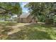 Tan house with large backyard and shed at 7803 Cadillac Ave, Hudson, FL 34667