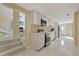 Modern kitchen with white cabinets, stainless steel appliances, and tiled floors at 7803 Cadillac Ave, Hudson, FL 34667